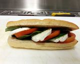 A picture of step 3 of Tomato Mozzrella with basil panini.