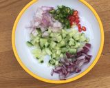 A picture of step 2 of Loaded Poppadoms / Poppadum Nachos topped with chilli and herbs 🌿🌱.