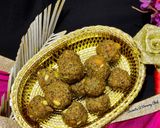 A picture of step 7 of Wheat flour seeds and nuts Ladoo with leftover ghee residue.