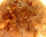 A picture of step 3 of Indian snack (crisp sphere with flavoured water/curd mixture).
