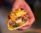A picture of step 3 of STEAK and SHREDDED CHICKEN BURRITOS WITH MELTED CHEESE/FRITOS: JAYS SMOTHERED BURRITO.