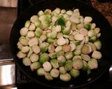 A picture of step 2 of Pan Fried Brussel Sprouts with Blood Orange and Applewood Bacon.