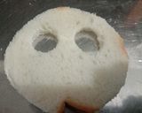 A picture of step 2 of Halloween spooky bread sandwich with tomato sauce.