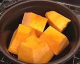 A picture of step 11 of Simmered Kabocha Squash in a Staub Cocotte.