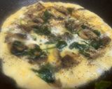 A picture of step 2 of Mushroom, spinach, egg omelette sandwich.