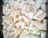 A picture of step 3 of rigatoni pasta and sauce baked.