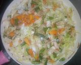 A picture of step 3 of White rice,palm oil stew and veg.sauce.