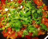 A picture of step 3 of Shakshuka (In my style- Poached eggs in tomato and veggie gravy).