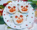 A picture of step 4 of Halloween spooky bread sandwich with tomato sauce.