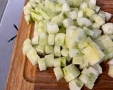 A picture of step 2 of Composed Salad with Black Tomatoes, Cucumber, Red Onion, Feta, and Parsley.