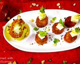 A picture of step 6 of Puliyogare cheese burst bombs in pizza sauce.