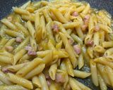 A picture of step 6 of Pennette with Pancetta, Yellow Cherry Tomato Sauce, and Pecorino (Fake Carbonara).