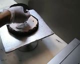 A picture of step 4 of 8 inch tall chocolate brownie cake.