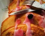 A picture of step 6 of Soufflé pancakes topped with blueberry cream.