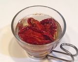 A picture of step 1 of Ajillo with Japanese Leek and Dried Tomatoes.