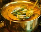 A picture of step 5 of Drum stick tomato masala curry (sambar) mixed with rice.