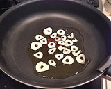 A picture of step 2 of Authentic Garlic Chicken in a Frying Pan.