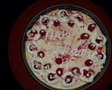 A picture of step 21 of White chocolate raspberry swirl cheesecake topped with raspberries and sauce.