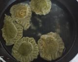 A picture of step 11 of Spinach Corn Ravioli in white sauce.