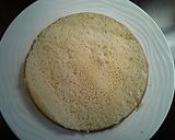 A picture of step 7 of White Butter Cake layered with Raspberry Cream with a White Chocolate Frosting.