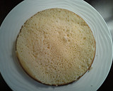 A picture of step 7 of White Butter Cake layered with Raspberry Cream with a White Chocolate Frosting.