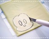 A picture of step 3 of Mickey and Minnie Onigiri Character Bento.
