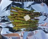 A picture of step 6 of Sticky Asian pork ribs with grilled asparagus over red wine feta aioli.
