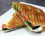 A picture of step 4 of Tomato Mozzrella with basil panini.