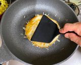 A picture of step 4 of Omu-Okonomiyaki (Japanese as-you-like pancake wrapped with egg).