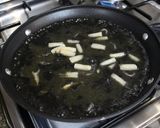 A picture of step 7 of Paella with Squid and Squid Ink.