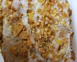 A picture of step 4 of Carrot & Banana Cake topped with icing and Banana crisp. 😀.
