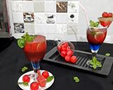 A picture of step 8 of Watermelon Mojito with blue Curacao.