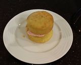 A picture of step 16 of Vanilla Butter Cakes filled and Frosted with Whipped White Chocolate Rasberry Ganache.