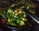 A picture of step 2 of Fried chilli with onion and raw mango.