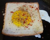 A picture of step 2 of Bread egg cheese grill slices.