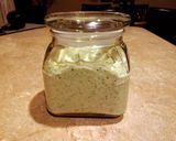 A picture of step 4 of Herbed green goddess dressing over lettuce wedges.