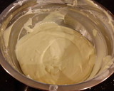 A picture of step 4 of White Layer Cake with a Raspberry Swirl Cheesecake center layer and a Raspberry Cream Frosting.