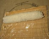 A picture of step 7 of How to Roll an Inside-Out Sushi Roll (California Rolls).
