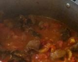 A picture of step 4 of Fried rice n plantain with chicken sauce garnished with kale leaf.
