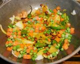 A picture of step 3 of Upma with puffed rice and colorful veggies.