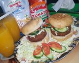 A picture of step 6 of Reshmi kabab burger with orange juice.