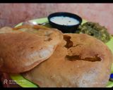 A picture of step 8 of Aligarh kachori with aloo sabji and raita.