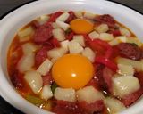 A picture of step 7 of Saganaki with Country Sausage, Eggs, and Graviera Cheese.