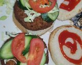 A picture of step 6 of Reshmi kabab burger with orange juice.