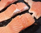 A picture of step 2 of Pan fried salmon on an open jacket with dill and butter.