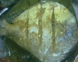 A picture of step 8 of Pomfret fry wrapped in turmeric leaves.