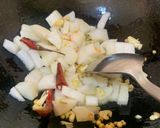 A picture of step 2 of Muli ka saag stir fried with besan (Radish greens with Gram flour).