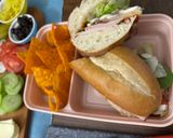 A picture of step 4 of Subway at home/ sub board.