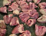 A picture of step 6 of Chicken Hearts Yakitori style (no skewer) Leek Green on top.