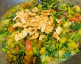 A picture of step 3 of Palak with brinjal and badi.